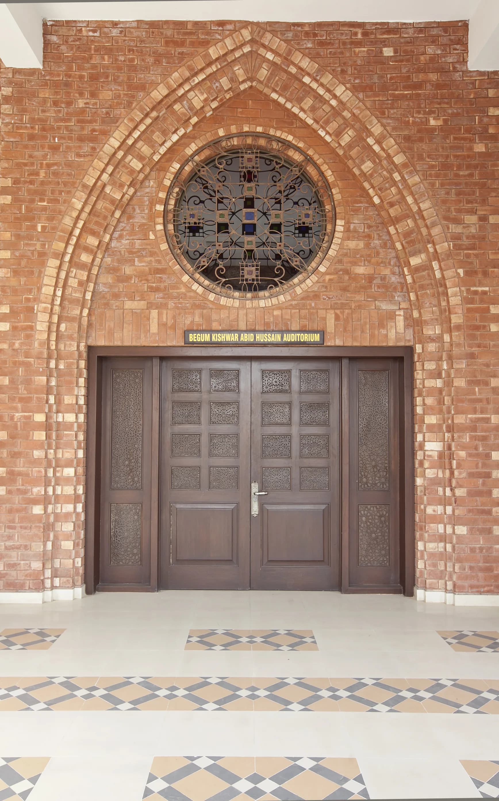 Brick auditorium entrance with decorative metalwork